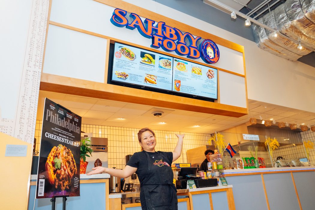 Pidor Yang, owner of Sahbyy Food, stands in front of her business' booth at Gather Food All in University City.