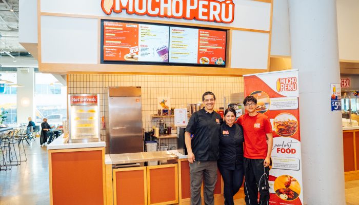 The proud business owners of Mucho Perú, stand in front of their booth at Gather Food Hall in University City.