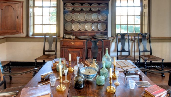 Color photo of a historic dining room staged with artifacts.