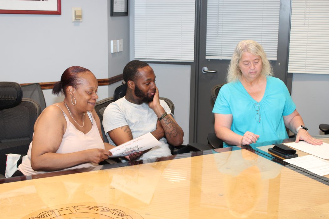 Former Philadelphia Department of Prisons Warden Michele Farrell (right) presents a check from the Correctional Peace Officers Foundation to Lisa Williams (left), Sergeant Williams’ mother, and his brother (center).