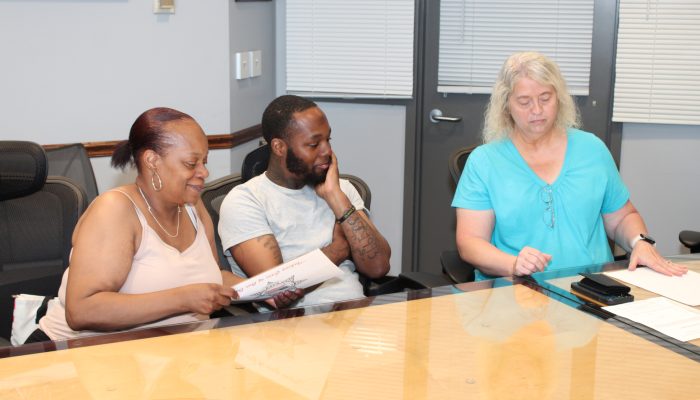 Former Philadelphia Department of Prisons Warden Michele Farrell (right) presents a check from the Correctional Peace Officers Foundation to Lisa Williams (left), Sergeant Williams’ mother, and his brother (center).