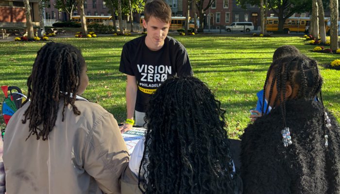 Luca Johnson tabling outside and talking to students.
