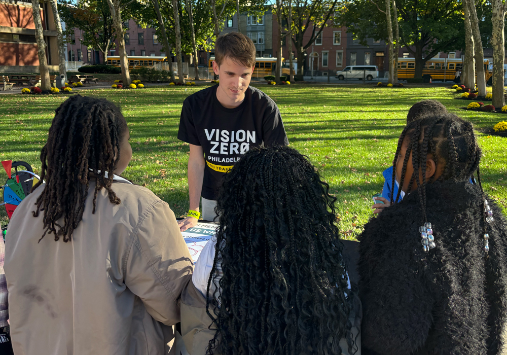 Luca Johnson tabling outside and talking to students.