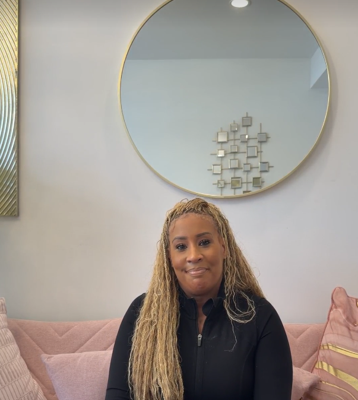 Danielle McLane, the CEO and executive director of Diamond Beauty Cosmetics & Academy, poses at her business.