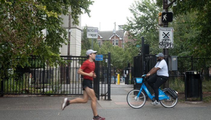 A jogger and a cyclist on the Schuylkill River Trail.