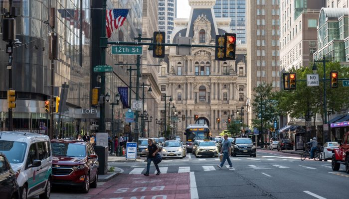 Market East facing City Hall, with a red bike lane in the frame