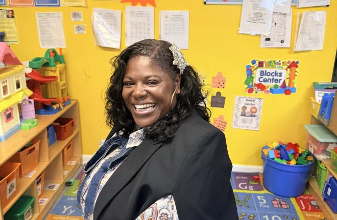 Dr. Kashmiera Harris smiling in a classroom at A Secure Future Academy, the childcare center she owns in University City.