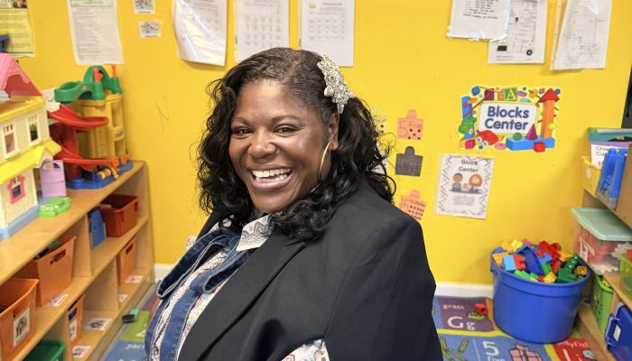 Dr. Kashmiera Harris smiling in a classroom at A Secure Future Academy, the childcare center she owns in University City.
