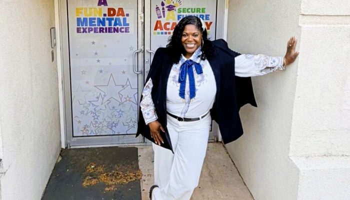 Dr. Kashmiera Harris standing in front of A Secure Future Academy, a childcare center she owns in University City.
