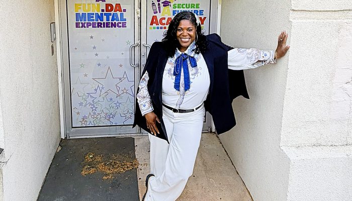 Dr. Kashmiera Harris smiles outside of A Secure Future Academy, a childcare center she owns in University City.