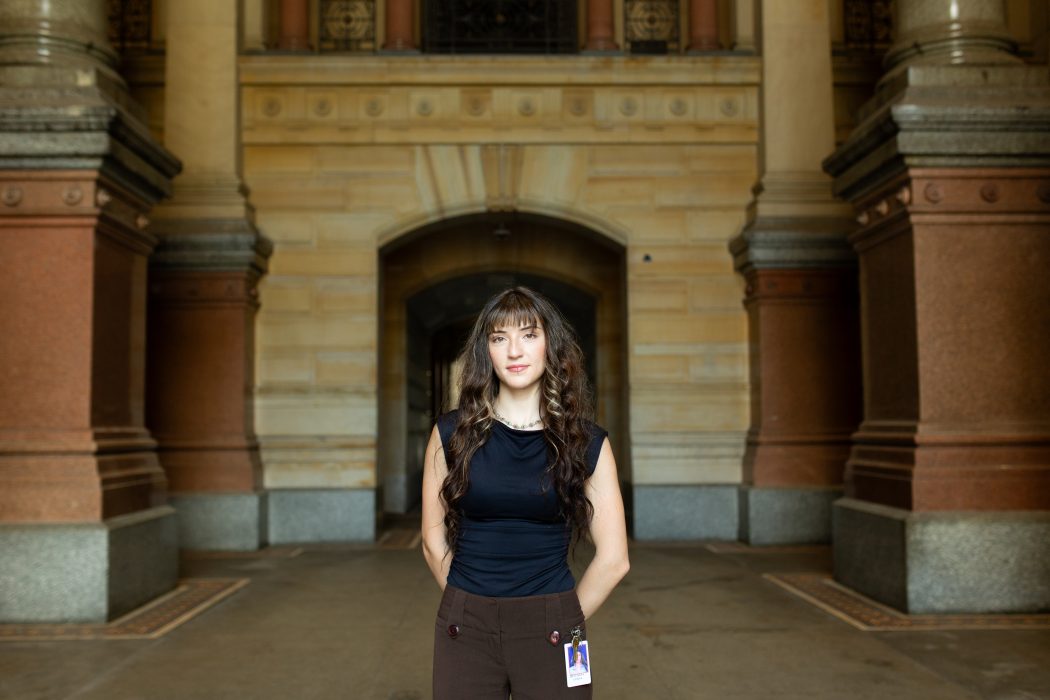 Image of intern Anfisa standing in front ot the City Hall archway.