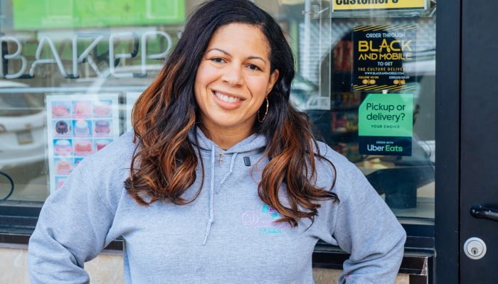 Business owner stands outside of Denise's Delicacies in North Philadelphia