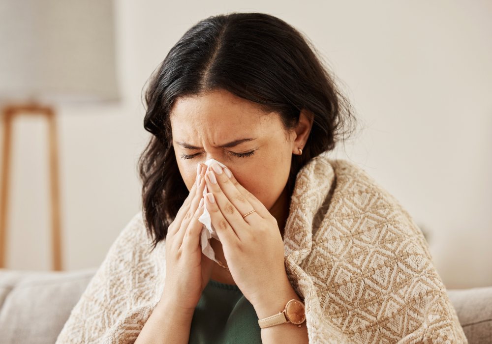 Sick woman blowing her nose