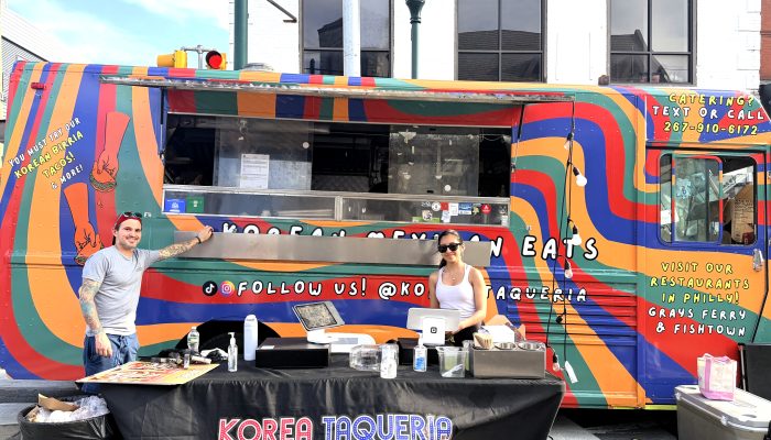 Staff stand in front of Korea Taqueria food truck at Girard Street Festival