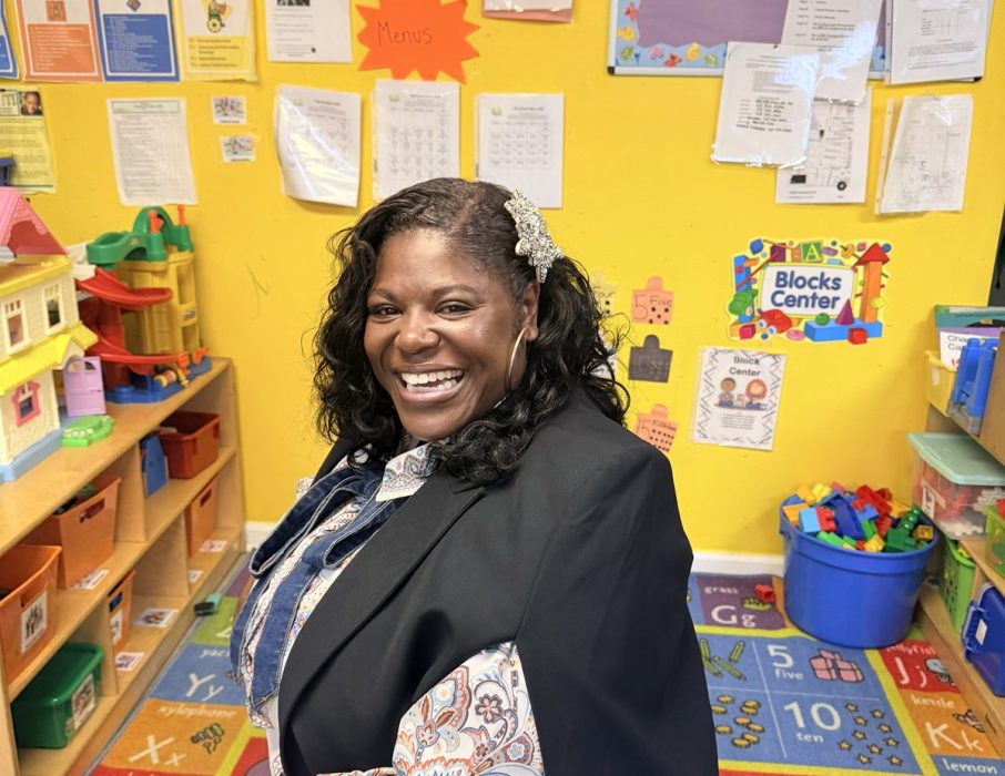 Dr. Kashmiera Harris smiling in a classroom at A Secure Future Academy, the childcare center she owns in University City.