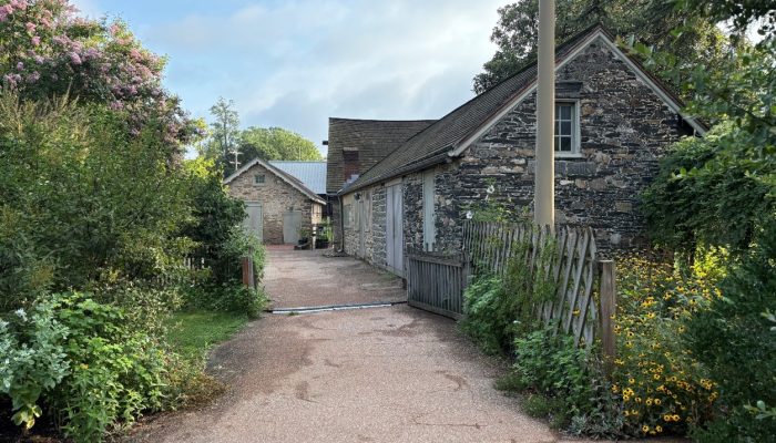 Photo of a path with two stone farm buildings