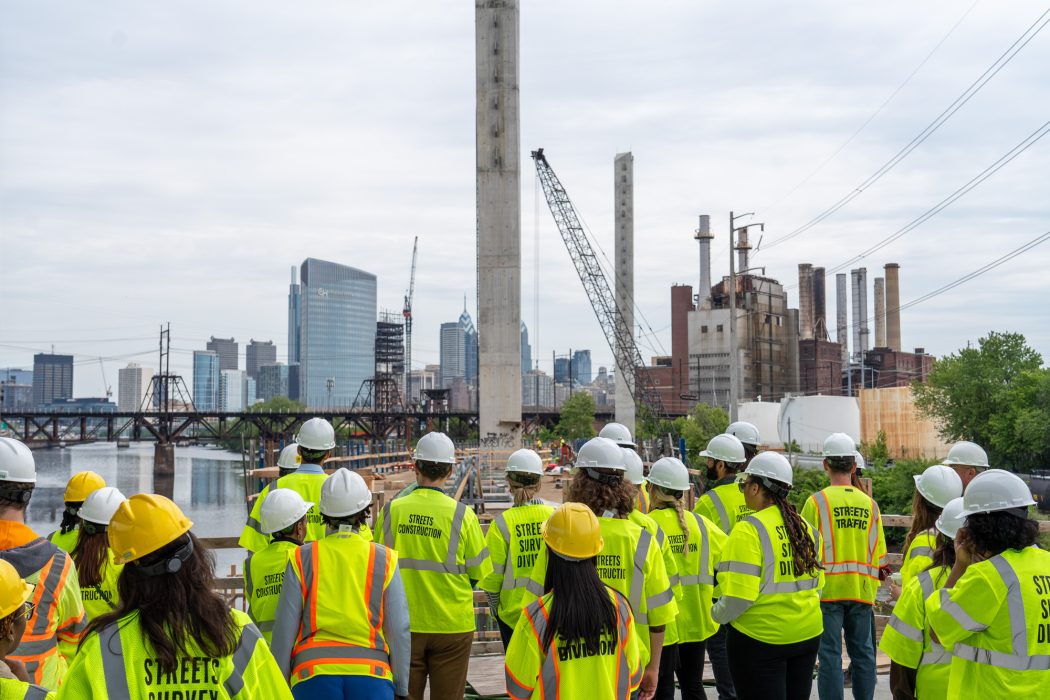 A crew in reflective vests admiring progress on the construction of the Christian to Crescent Connector Bridge