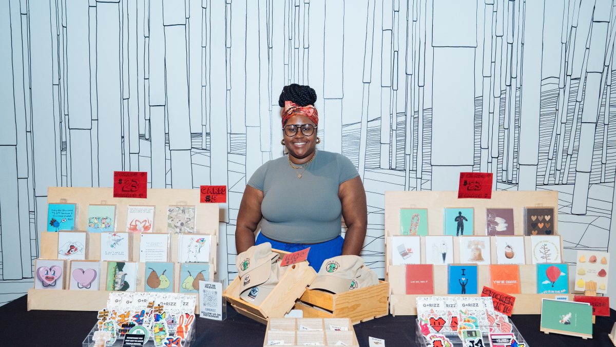 Retail vendor behind a black table with cards