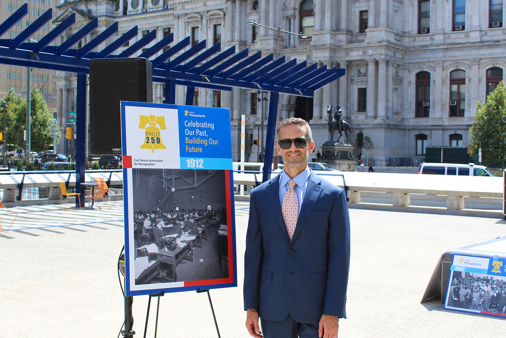 Commissioner Leonard standing next to one of the photo displays.