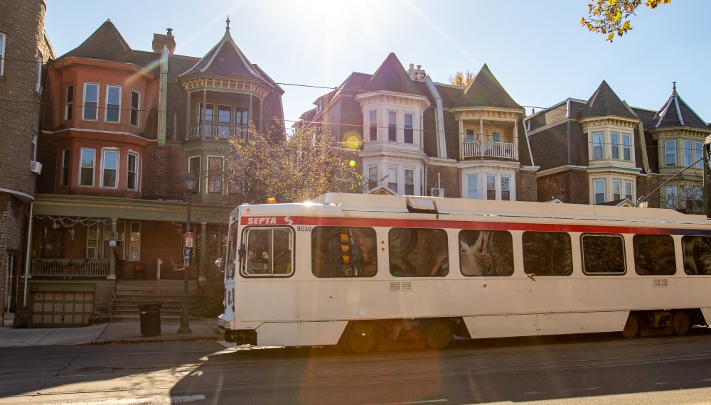 A SEPTA trolley passes by twin houses in West Philadelphia