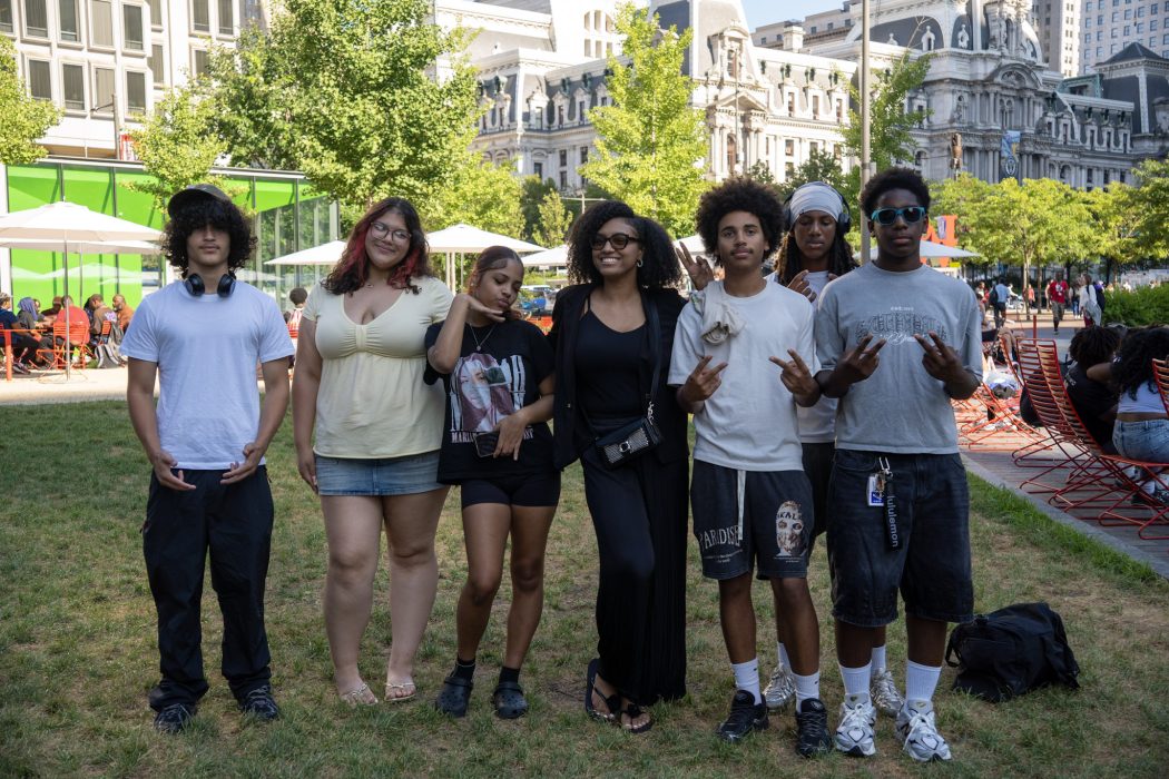 A group of young people pose for a photo in Love Park.