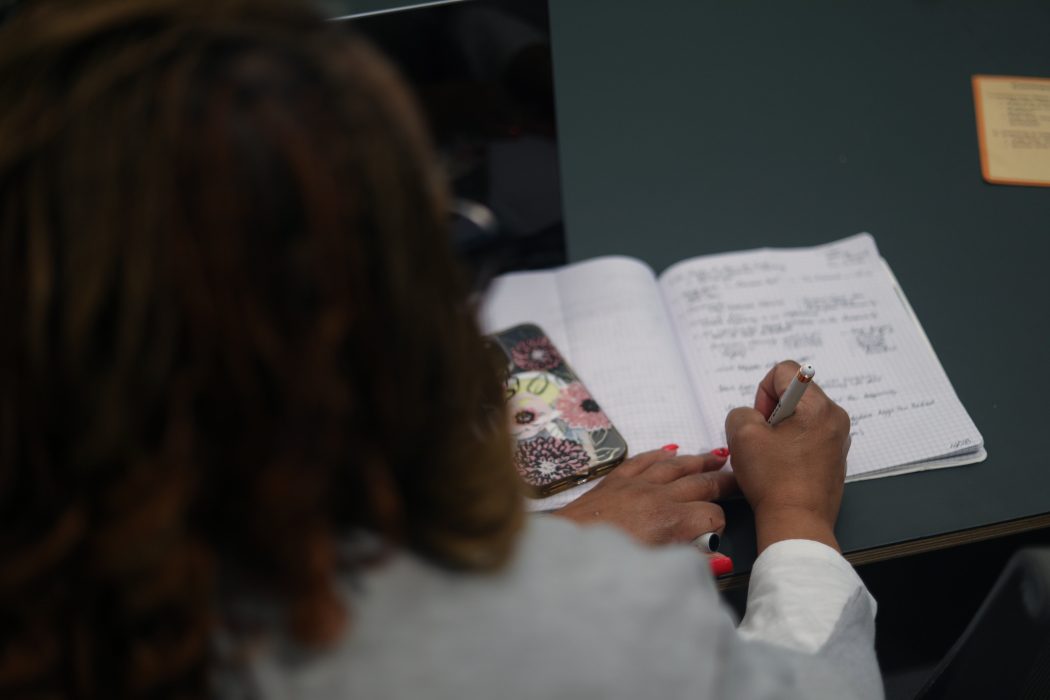 Business owner taking notes in a notebook