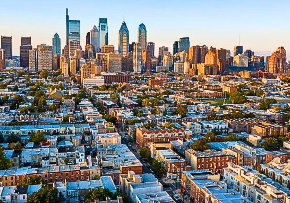 Bird's-eye view of Philadelphia homes with the city skyline in the distance